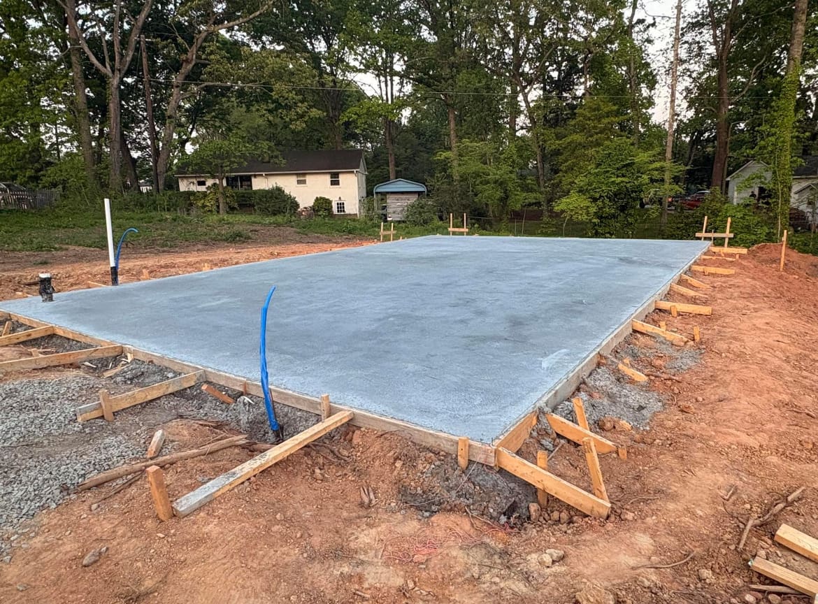 Finished Concrete Foundations job in Charlotte, North Carolina by Local Concrete Charlotte — clean control-joint pattern, smooth troweled surface, full property protection during pour.